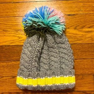 Beanie with oversized multi-colored puff ball